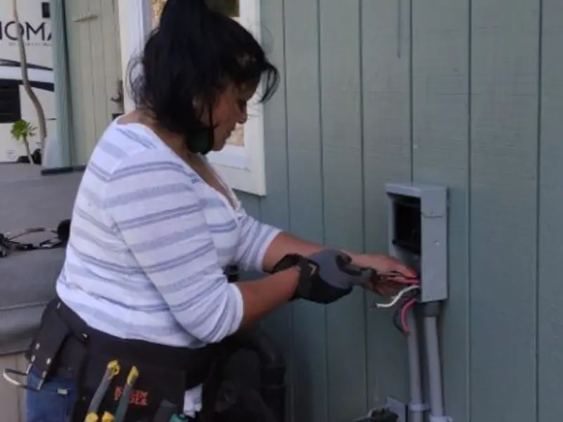 Licensed electrician wiring an exterior subpanel in Emporia